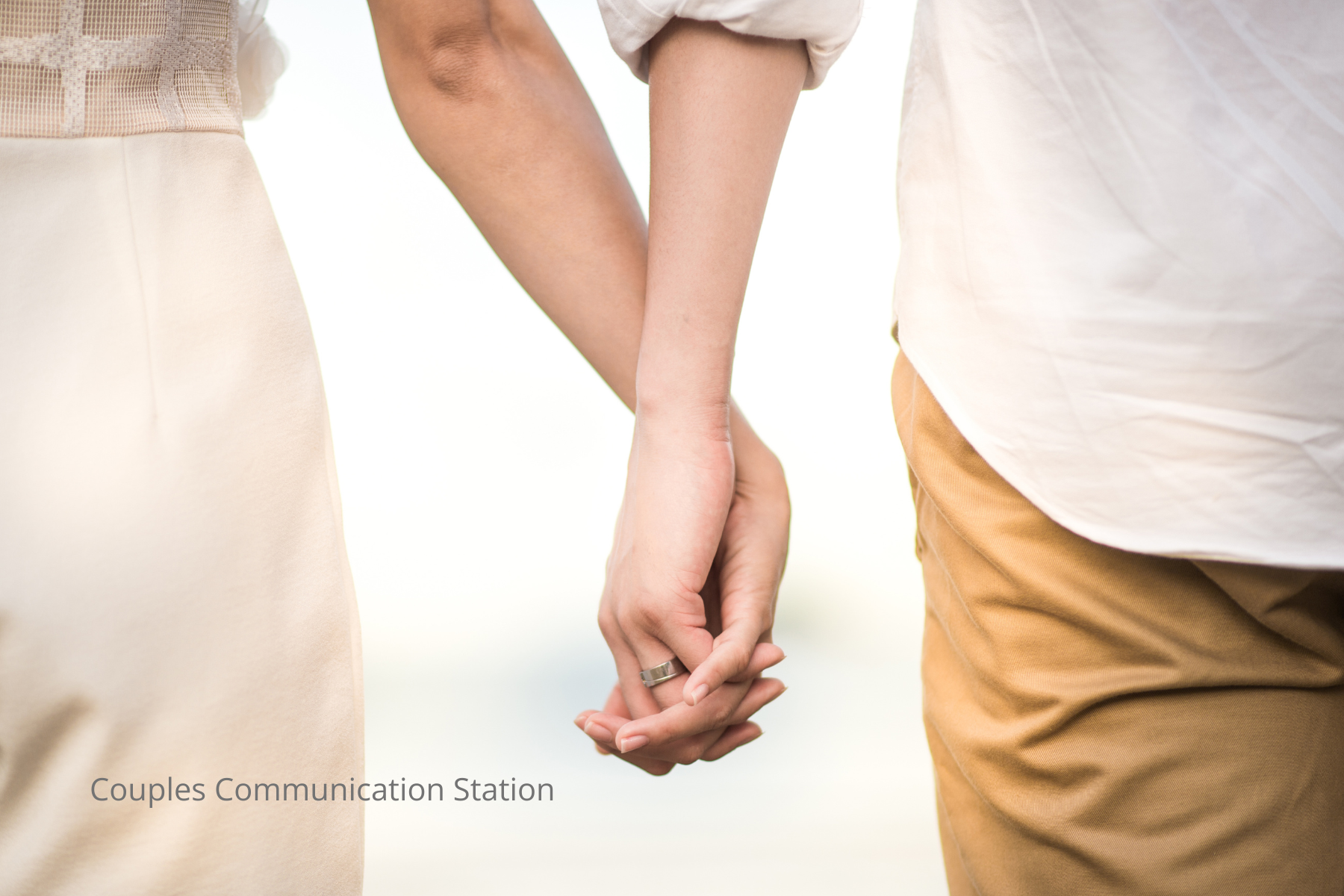 Close-up of a couple holding hands, symbolizing support and recentering after an emotional hangover.