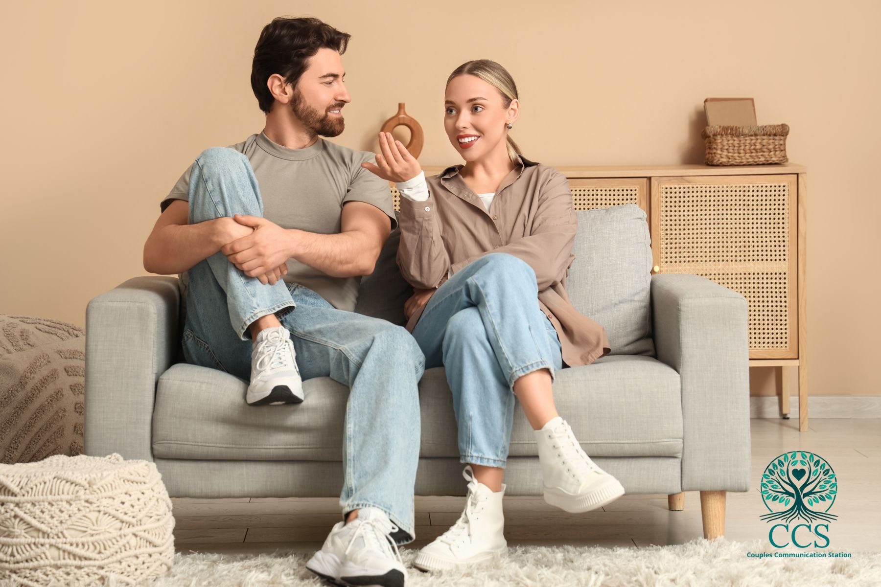 Smiling couple sitting together and having a relaxed conversation, representing positive communication in relationships.